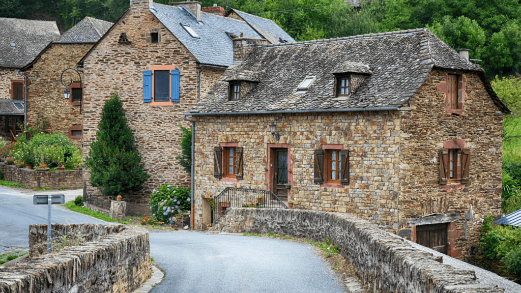 an old stone house on a country road in france