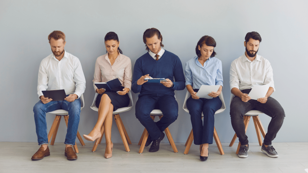 Applicants with resumes in hands waiting for a job interview