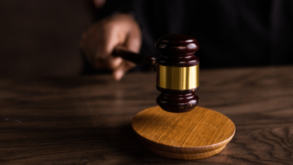 a judge's gavel on top of a wooden table