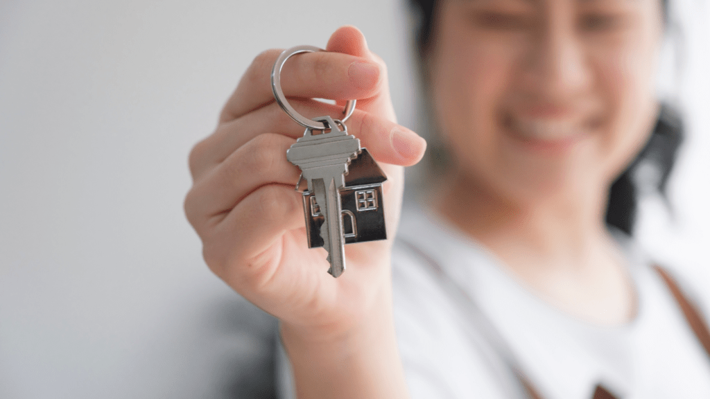 a person holding a house key