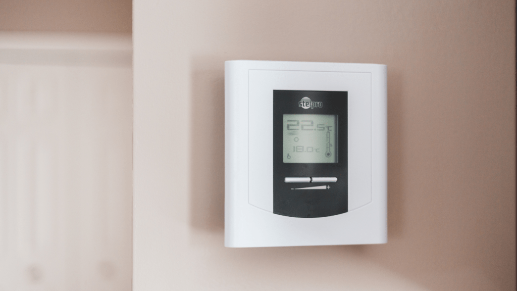 a digital thermostat mounted on the wall