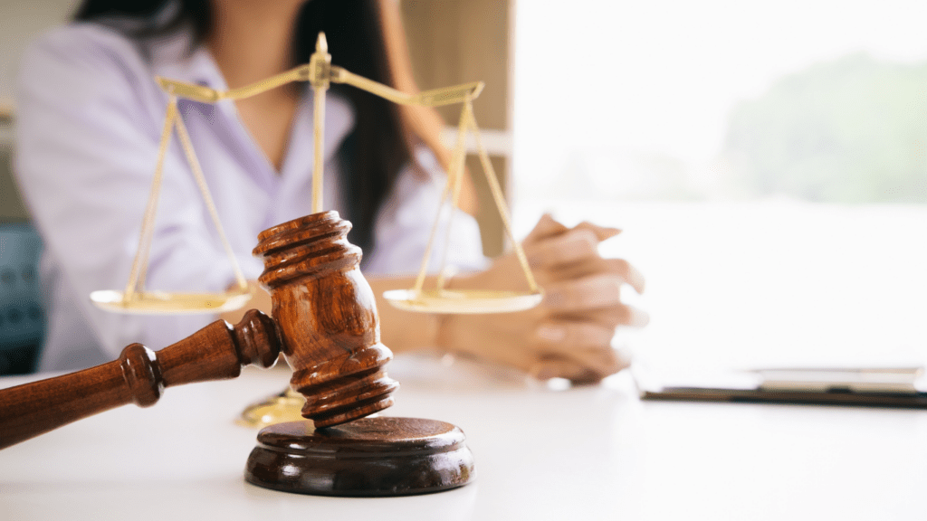 a judge's gavel on top of a wooden table