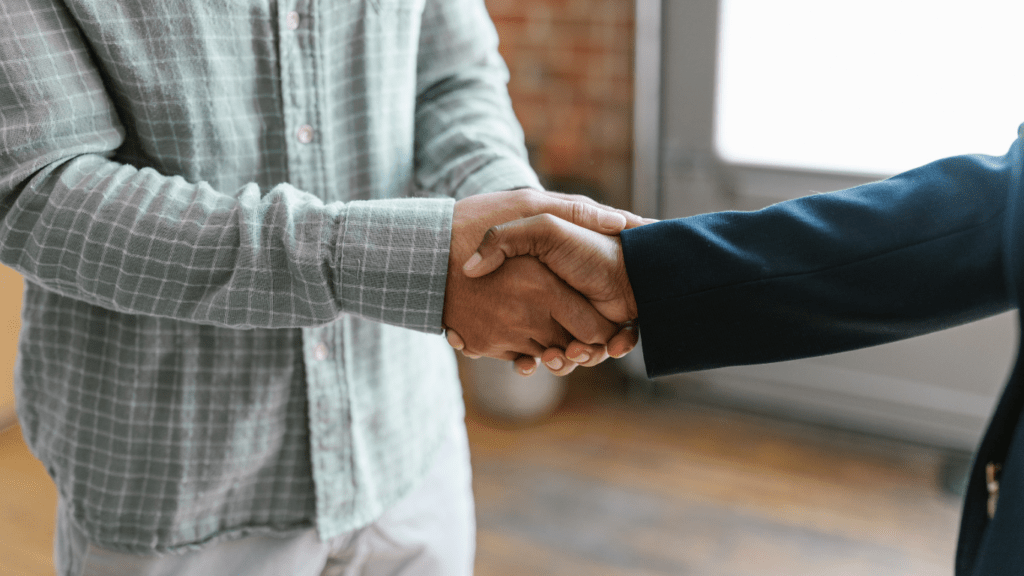 two people shaking hands in an office